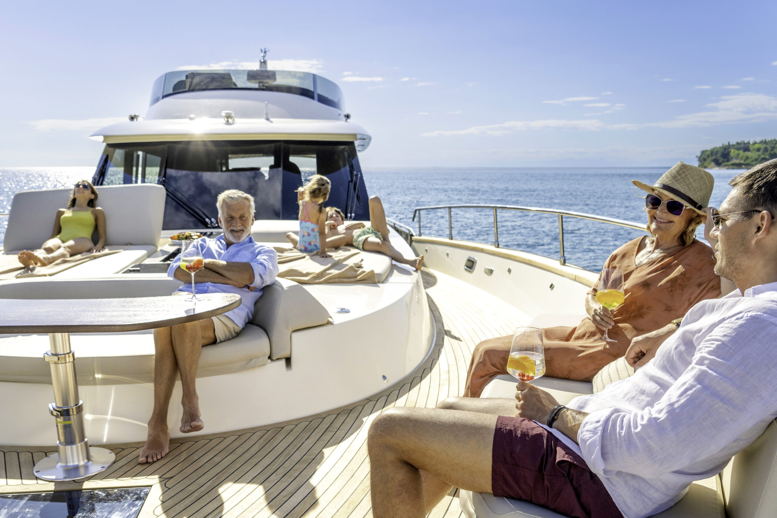 Exclusive Yacht Club - Multigenerational family enjoying cruise on yacht on sunny day