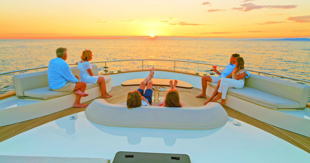 Family relaxing on yacht with a gorgeous sunset - Exclusive Yachts Club