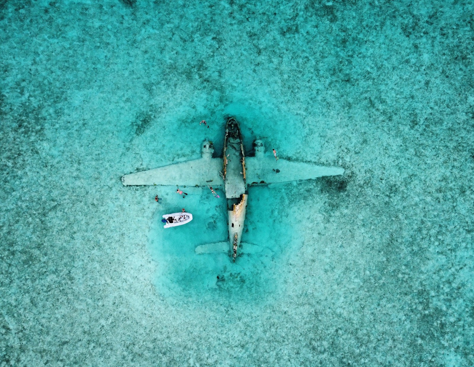 Exclusive Yachts - The famous plane wreck at Norman's Cay in the Bahamas. The WWII-era plane belonged to Pablo Escobar's drug cartel. It was thought to be carrying cocaine when it landed in the water, just shy of the runway in 1980.Nowadays the wreck is a popular snorkeling site.