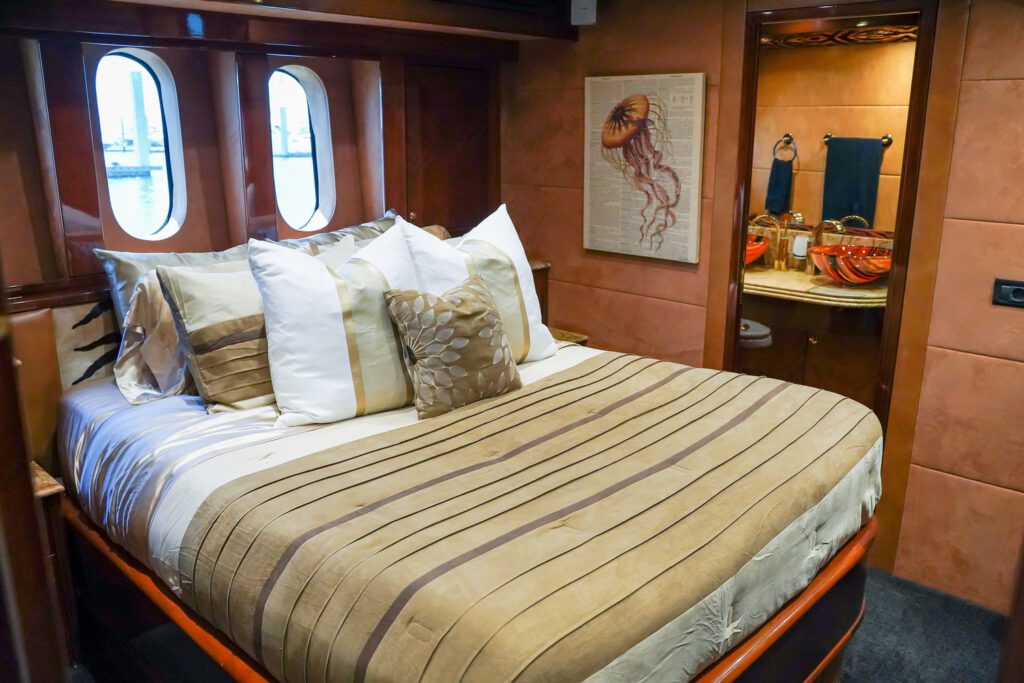 Exclusive Yachts - Welcoming guest cabin with striped bedding and a warm, inviting atmosphere on the MY Star Sapphire.