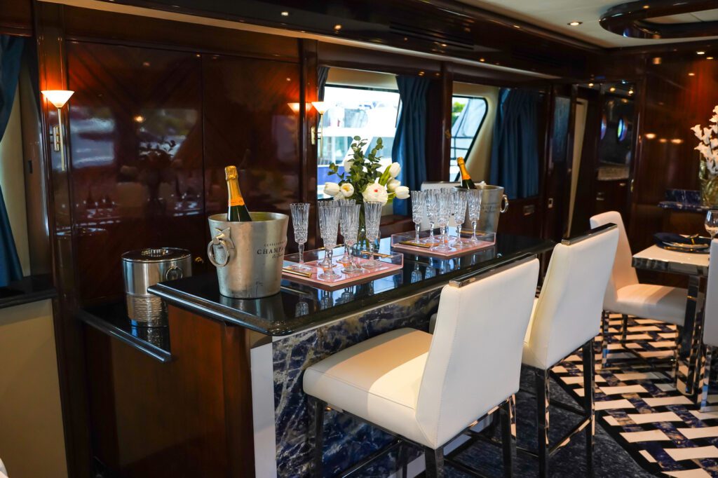 Exclusive Yachts - The sophisticated bar area inside the MY Star Sapphire showcases crystal glassware and chilled champagne, epitomizing luxury at sea.