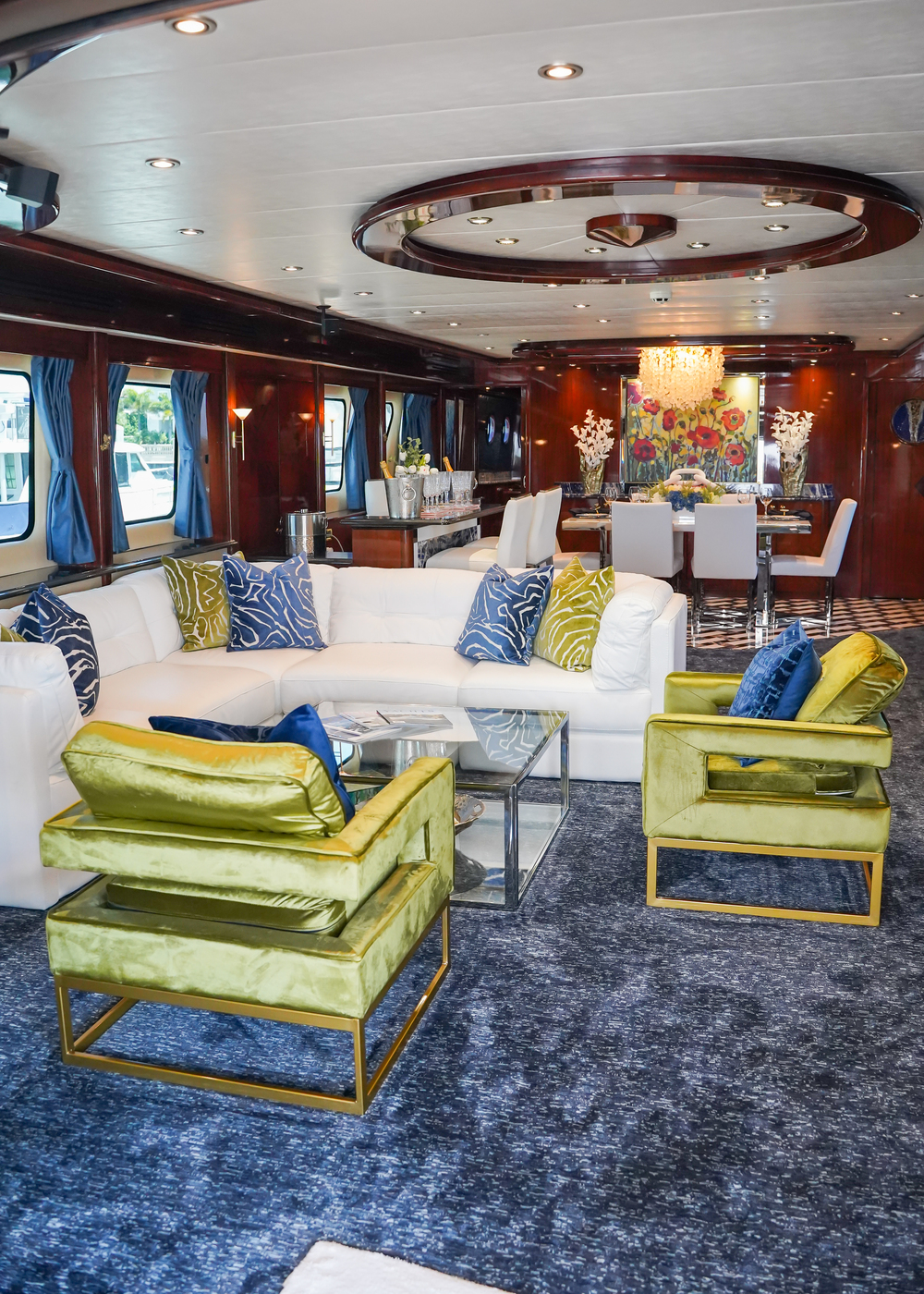 Main Salon - Motor Yacht Star Sapphire - Exclusive Yachts Superyacht - Tampa St Pete Exclusive Yachts - The MY Star Sapphire's main salon radiates luxury with rich wood paneling, plush velvet seating, and vibrant accent pillows.