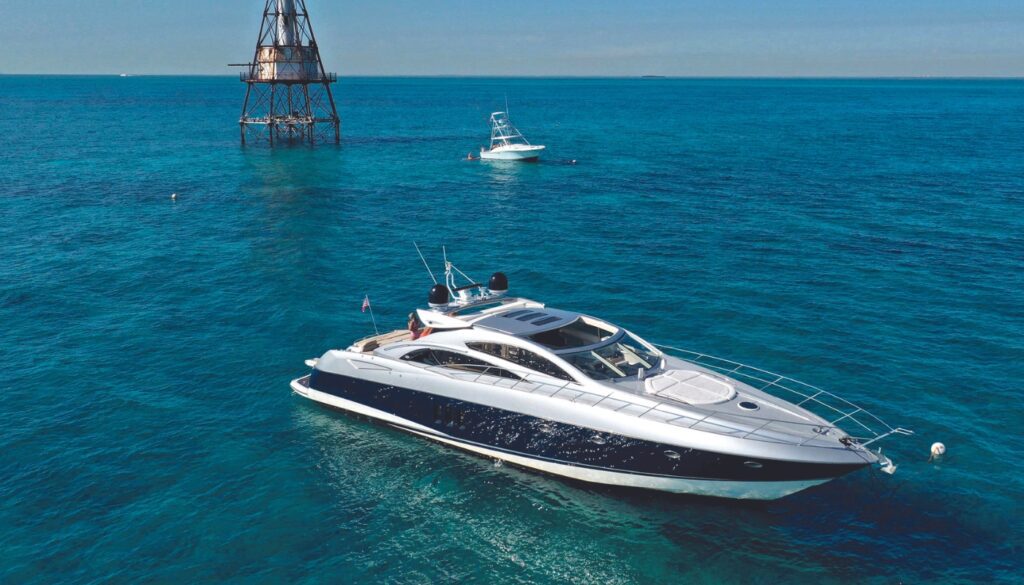 Exclusive Yachts - 72 Sunseeker on the water next to a lighthouse